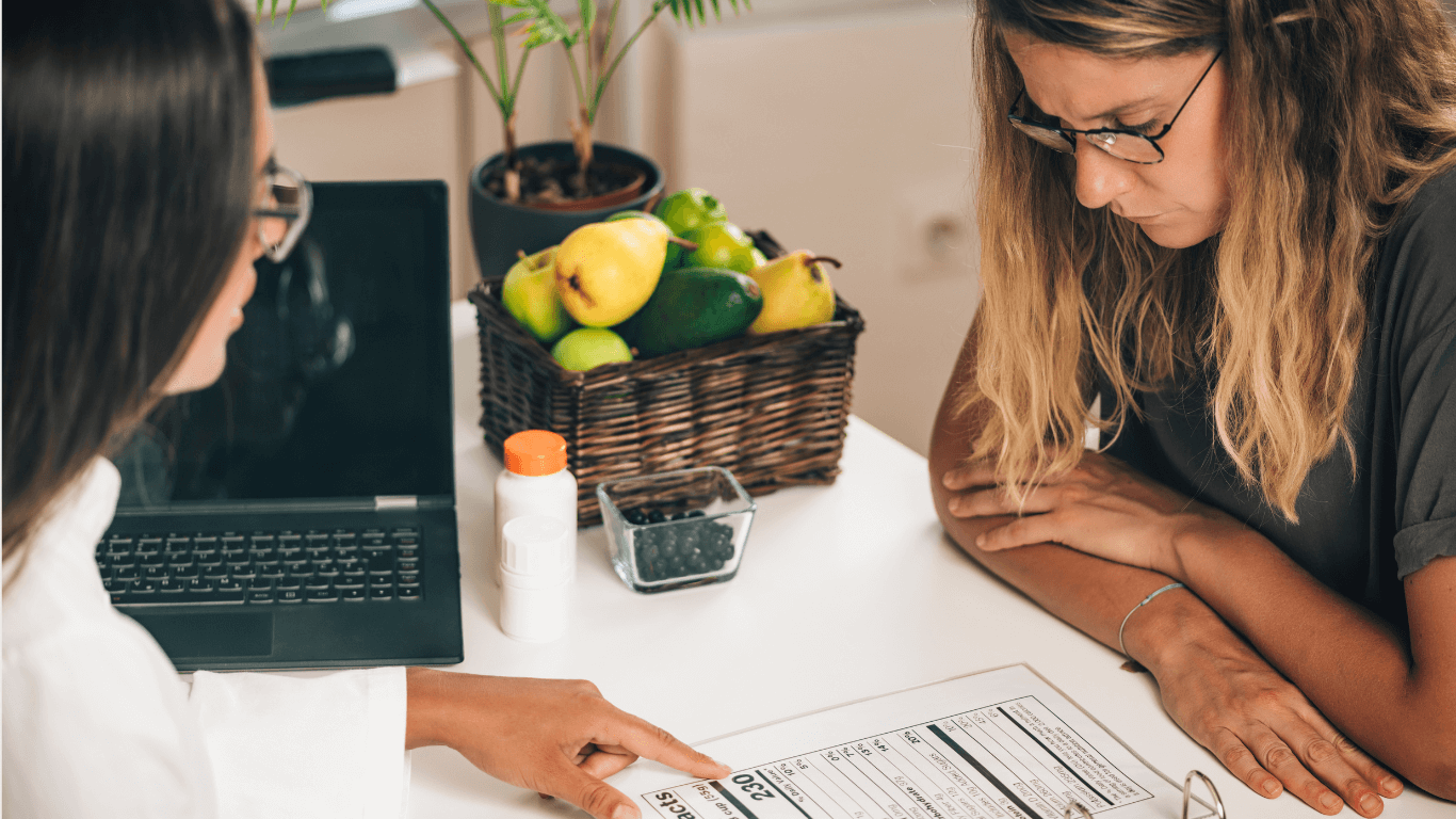 FoodisMedicinehero (1) Women pointing to nutrition facts to another woman listening attentively